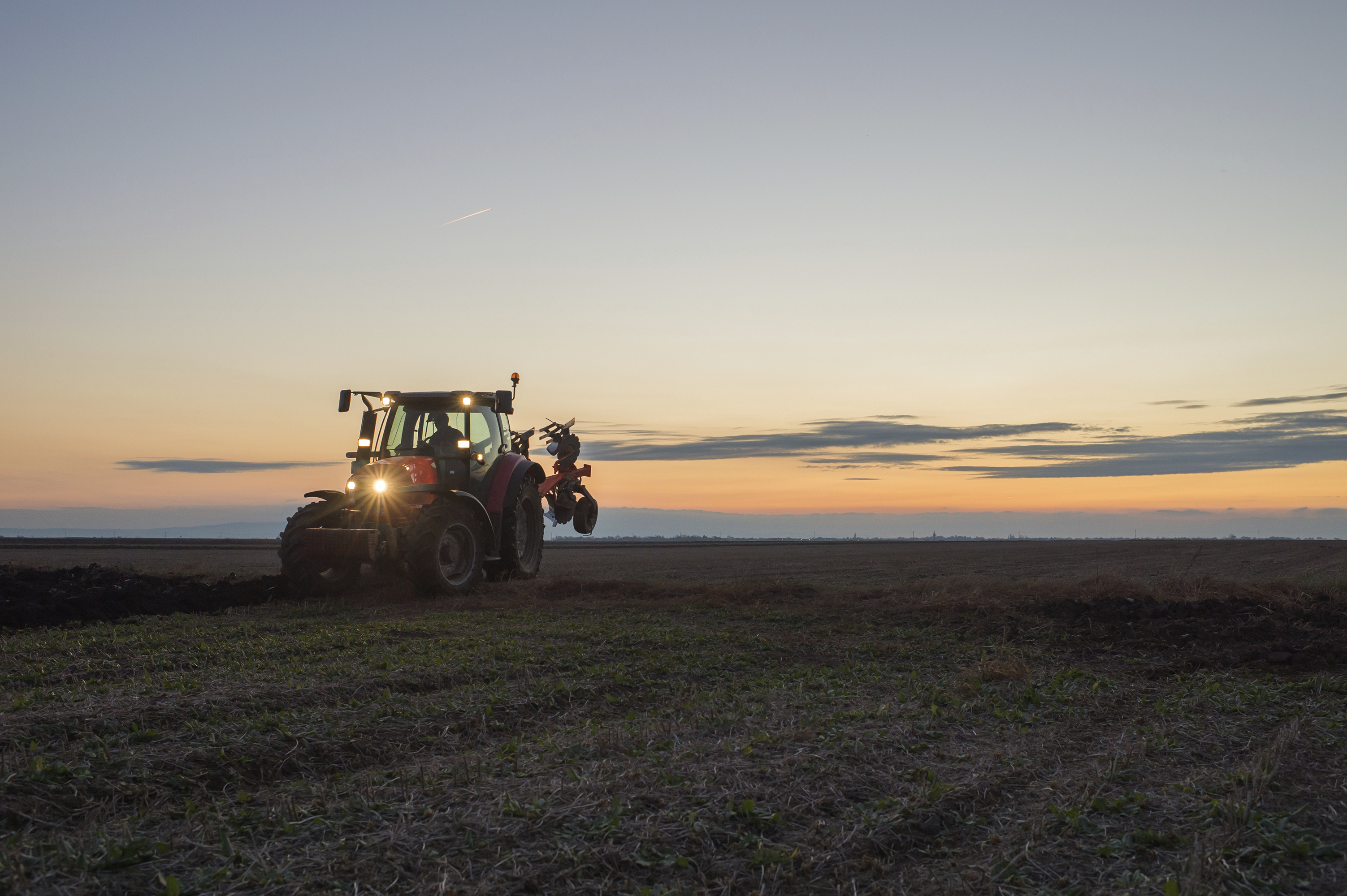 Farm tracker at evening in a field